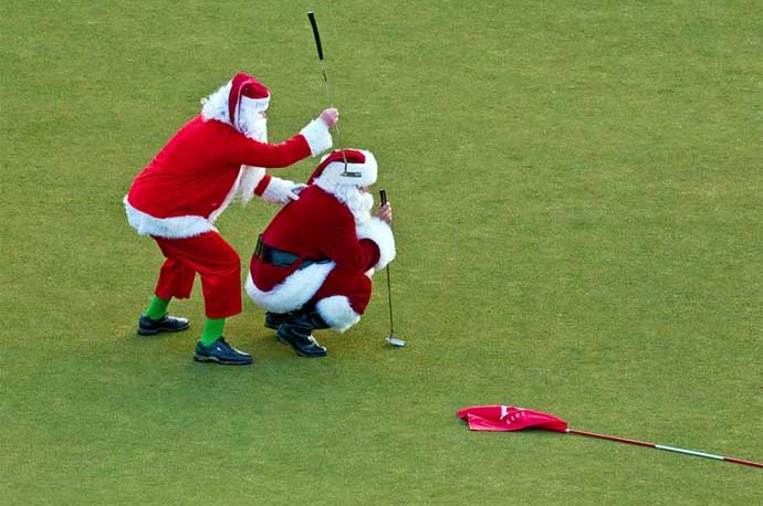 Santa putting on a golf green