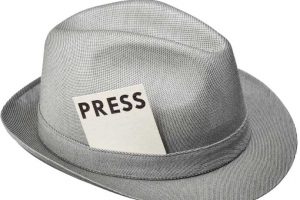 Golf writer intern might wear a hat with a press card in the hat band