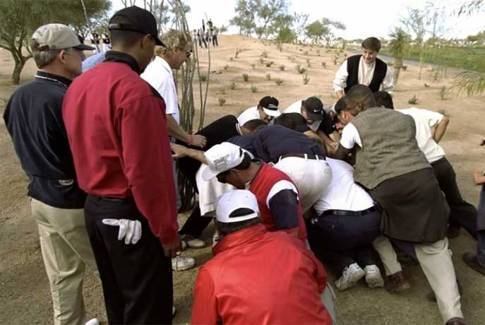Tiger Woods watches fan move a boulder at the 1999 Waste Management Phoenix Open